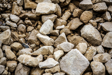 An abstract close up photo of a variety of different sized stones from a quarry. Perfect for background use