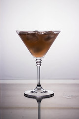 cocktail glass with drink on a light background