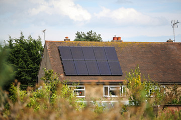 A rural house that has had solar panels installed on the roof to generate renewable clean green energy