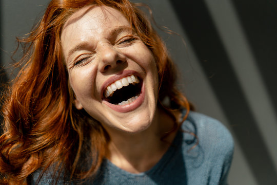 Portrait of laughing redheaded woman