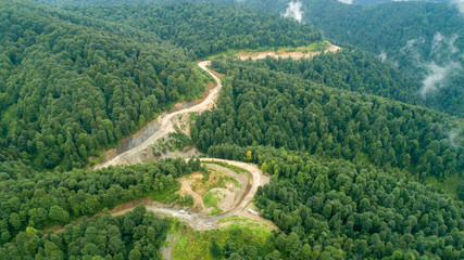 Mountine road in wild forest to reservation zone in Russia