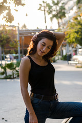 Fototapeta premium Portrait of a young woman in a park of the city