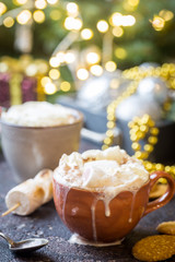 hot cocoa with marshmallows, cream and cookies on holiday christmas background