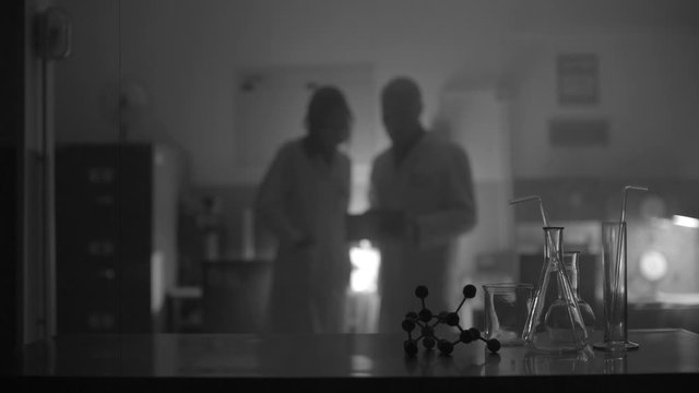 Scientists working together in a dark lab