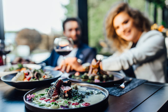 Close Up Photo, Two Person Eating Salade And Drink Wine.