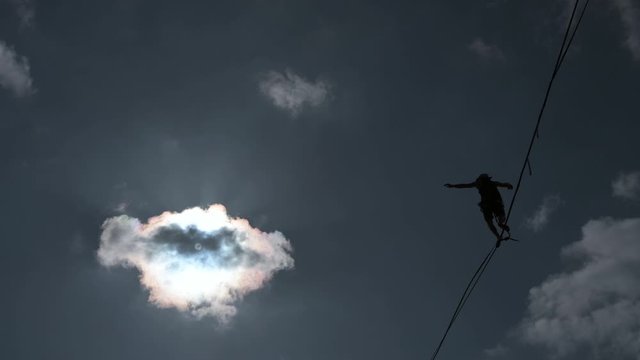 silhouette of man on highline, slackline