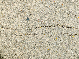 erosion trace on a grey concrete floor causing a break