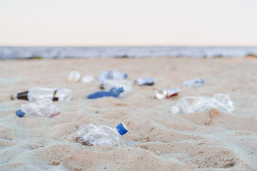 Fototapeta na wymiar Environmental or polution concept. Empty plastic bottles on sea beach