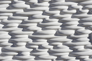 Obraz premium decorative concrete wall with wave-shaped embossment pattern in light gray and deep shadows
