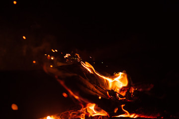 Beautiful abstract background on the theme of fire, light and life. Burning red hot sparks fly from...
