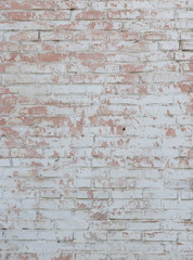  old white brick wall with light red scuffs and sprinkled paint vertical layout