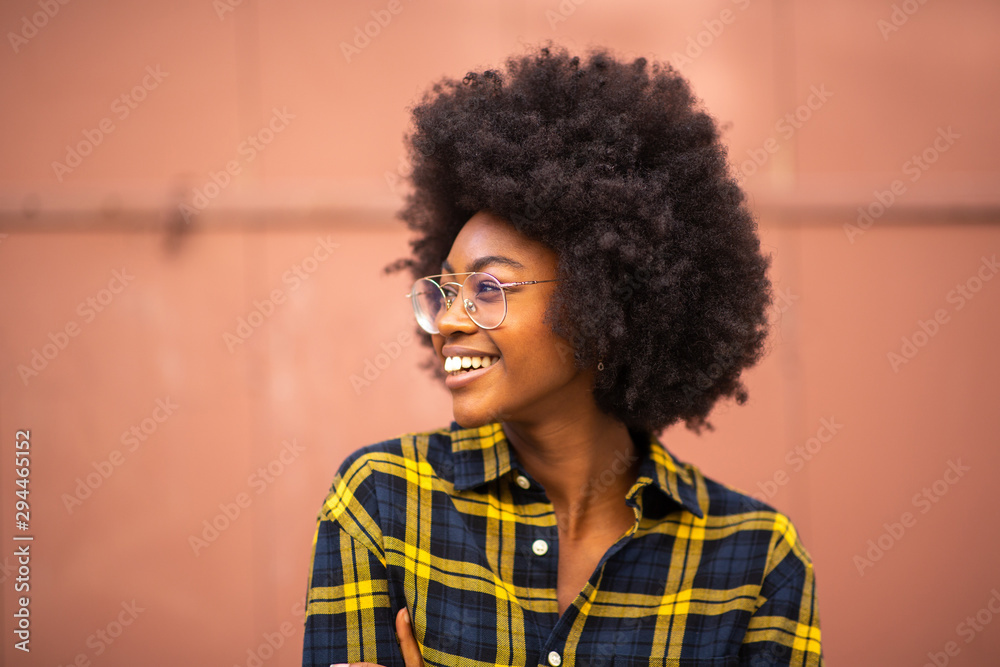 Poster young african american woman with afro and glasses looking away