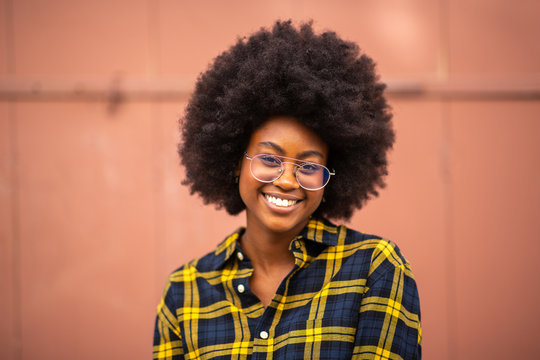 front portrait of young african american woman with afro and glasses
