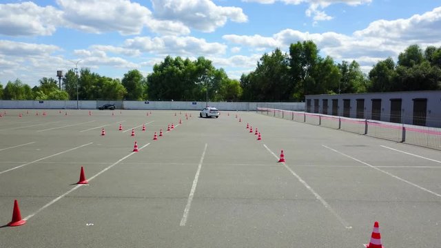 aerial view of police car at the autodrome, asphalt autodrome with road markings driving exam, police car racing car driving on a racetrack aerial