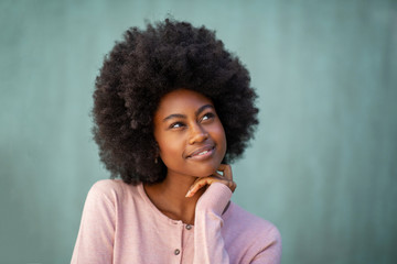 beautiful young black woman with afro thinking and glancing away