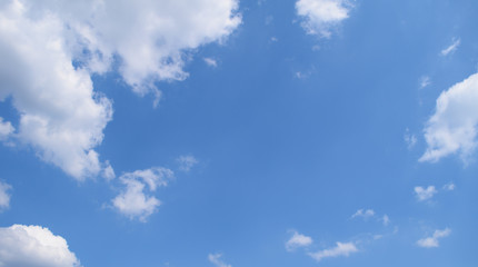Bottom view of the blue sky and white clouds. Background, texture.