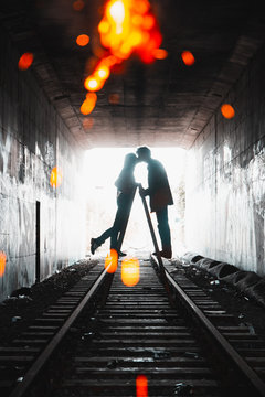 Silhouette of person standing on a-frame ladder