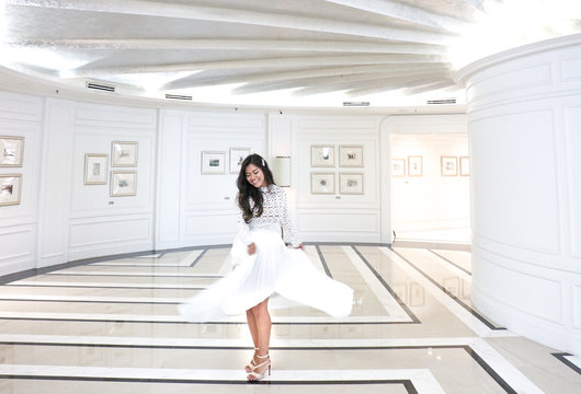 Smiling woman wearing white dress