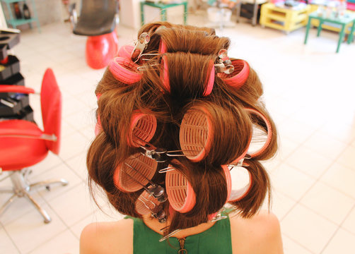 Woman's long brown hair with curlers