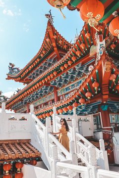 Woman standing beside pagoda house