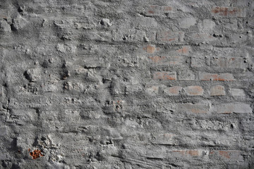 Old vintage cracked bricks with concrete texture.