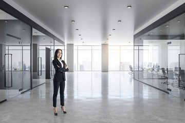 Fototapeta na wymiar Businesswoman in concrete office