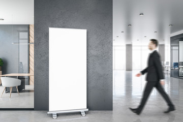 Businessman in modern office with banner