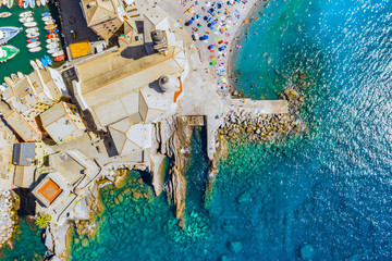 Aerial view of Camogli. Castle della Dragonara near the ligurian sea beach. View from above on rock and sea with transparent turquoise clean water and stones at the bottom.