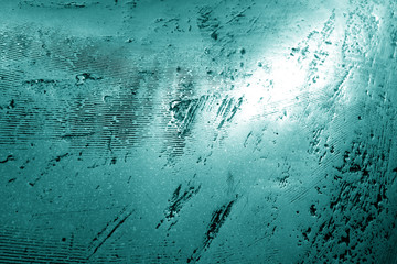 Part of bronze sculpture close-up in cyan tone.