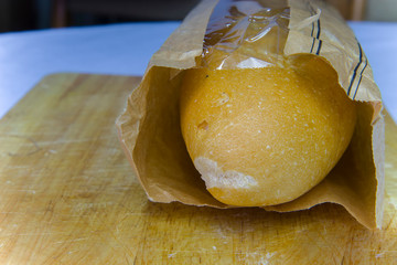 Fresh Baguette in a paper bag closeup copy space.