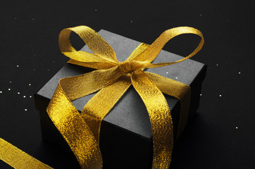 Holiday gift box with bow top view background. Birthday surprise, Christmas present and golden tape...