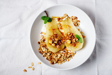 Poached pear with granola.