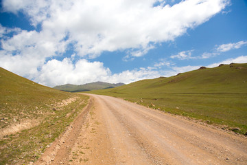 Fototapeta na wymiar Road to Song kol lake - landscape of high plateau in Kyrgyzstan