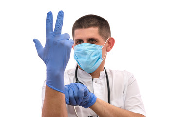 young doctor in uniform getting ready to work putting on gloves isolated on a white background