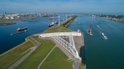 Rolgordijnen Aerial picture of Maeslantkering storm surge barrier on the Nieuwe Waterweg Netherlands it closes if the city of Rotterdam is threatened by floods and is one of largest moving structures on earth © Tjeerd