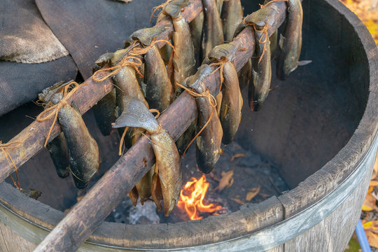 Traditional Scottish Smoked Fish Cooking In Wooden Barrel. Ancient Way Of Smoked Meat. 