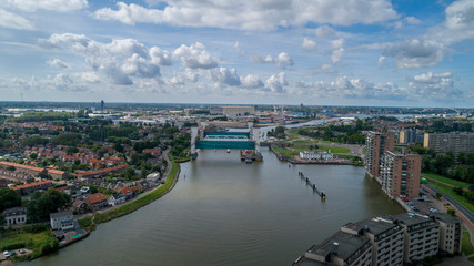 Fototapeta premium the lifted Algera flood barrier in the river Hollandse IJssel in the background on a sunny day in summertime