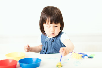 toddler girl paiting at home