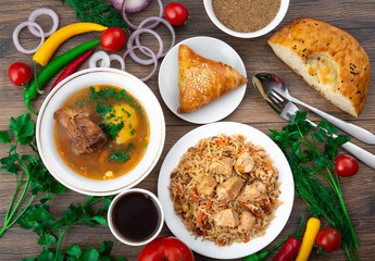 Assorted Uzbek food set, pilaf, samsa, lagman, manta, shurpa Uzbek restaurant concept, Uzbek