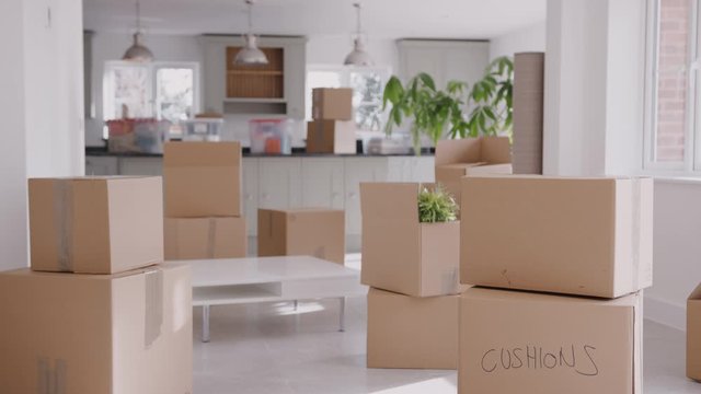 Pull Focus Shot Of Removal Boxes Inside Empty Room On Moving Day