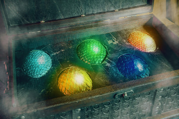 View of dragon eggs in old wooden treasure chest.