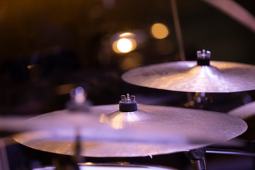 Fototapeta premium Two crash cymbals of a drumset in stage lighting