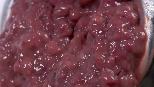 pieces of the liver come out through the holes in the meat grinder when scrolling, it looks very nasty and it looks like the human intestines are scrolling, close-up