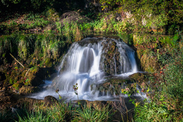 Obraz premium Small waterfall in a forest in Krupa na Vrbasu by the Banja Luka in Bosnia and Herzegovina