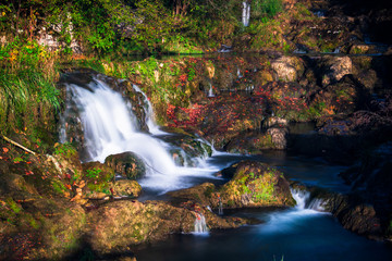 Fototapeta na wymiar Small waterfall in a forest in Krupa na Vrbasu by the Banja Luka in Bosnia and Herzegovina