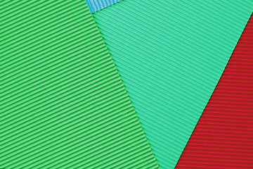 Sheets of colored embossed paper. Laid one on top of the other. Abstractions and backgrounds. Close-up.