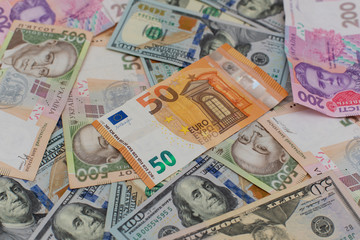 Multi currency money dollars and hryvnia, close-up top view concept finance investment