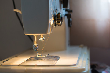 Needle on sewing machine while sewing clothes.