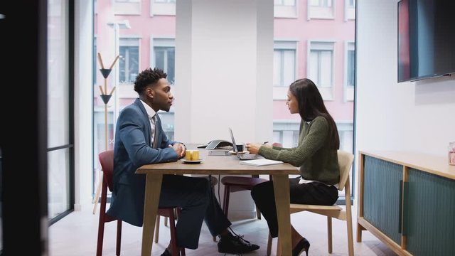 Businesswoman Interviewing Male Job Candidate In Meeting Room
