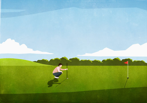 Male golfer preparing tee shot on sunny golf course
